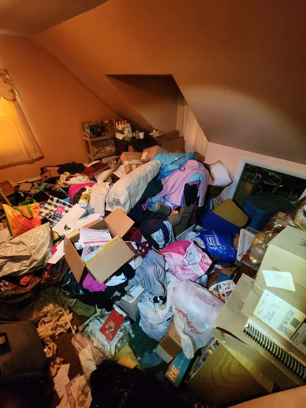 Actual Biohazard PRO property showing a heavily cluttered bedroom before a full cleanout